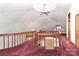 Hallway with red carpet, wooden railing, a ceiling fan, and a skylight at 443 Troutman Farm Rd, Statesville, NC 28677