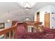 Hallway with red carpet, wooden railing, a ceiling fan, and a skylight at 443 Troutman Farm Rd, Statesville, NC 28677