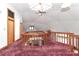 Hallway with red carpet, wooden railing, a ceiling fan, and a skylight at 443 Troutman Farm Rd, Statesville, NC 28677
