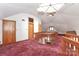Hallway with red carpet, wooden railing, and skylight at 443 Troutman Farm Rd, Statesville, NC 28677
