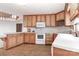 Spacious kitchen with wooden cabinetry, white appliances, and ample storage space at 443 Troutman Farm Rd, Statesville, NC 28677