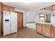 Open-concept kitchen with wooden cabinets, white appliances, and a view into the next room at 443 Troutman Farm Rd, Statesville, NC 28677