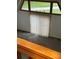 Sunlit living room featuring an expansive window and a wood railing overlooking the downstairs at 443 Troutman Farm Rd, Statesville, NC 28677