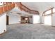 Spacious living room with open floor plan, modern gray carpet, and a view of the kitchen at 443 Troutman Farm Rd, Statesville, NC 28677