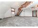 Bright living room with plush gray carpet, wood trim, and an open staircase, providing natural light at 443 Troutman Farm Rd, Statesville, NC 28677
