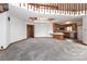 Open living space with gray carpet, a view of the kitchen, and a unique multi-level design at 443 Troutman Farm Rd, Statesville, NC 28677