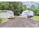 Outbuildings with gravel drive provide ample storage and workspace on this unique property at 443 Troutman Farm Rd, Statesville, NC 28677