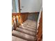 Carpeted staircase with wooden railing, leading to the upper level, providing a secure and comfortable transition at 443 Troutman Farm Rd, Statesville, NC 28677