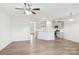 Open-concept living space with modern kitchen and hardwood floors at 5254 Spanish Ivy Ln # 133, Indian Land, SC 29707