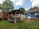 A well-maintained backyard featuring a covered patio, a detached garage, and a brick home at 557 Melbourne Ct, Charlotte, NC 28209