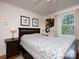 Serene bedroom featuring hardwood floors, a classic bed frame, and large windows for natural light at 557 Melbourne Ct, Charlotte, NC 28209