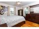 Cozy bedroom with a ceiling fan, hardwood floors, and plenty of natural light from the large windows at 557 Melbourne Ct, Charlotte, NC 28209