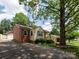 Charming home showcasing mixed siding, a gravel driveway, and well-manicured landscaping at 557 Melbourne Ct, Charlotte, NC 28209