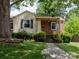 Charming single-story home with brick accents, a welcoming porch, and a well-manicured front yard at 557 Melbourne Ct, Charlotte, NC 28209