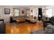 Spacious living room featuring hardwood floors and an open layout into the dining room at 557 Melbourne Ct, Charlotte, NC 28209