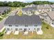 Aerial view of new townhomes with back patios and well-maintained landscaping at 5625 Axil Ln, Charlotte, NC 28269