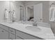 Bathroom featuring double sinks with white countertops and a view into the adjacent bedroom at 5625 Axil Ln, Charlotte, NC 28269