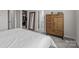 Bright bedroom featuring a closet, a mirror, and a modern, wooden dresser with ample storage at 5625 Axil Ln, Charlotte, NC 28269