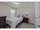 Cozy bedroom featuring a comfortable bed, a nightstand, and natural light from a window at 5625 Axil Ln, Charlotte, NC 28269