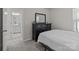 Bedroom with a dark dresser, neutral walls, and an ensuite bathroom at 5625 Axil Ln, Charlotte, NC 28269