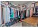 Organized walk-in closet featuring multiple shelves, hanging rods, and drawer storage at 5625 Axil Ln, Charlotte, NC 28269