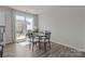 Cozy dining area features a round table, seating for four, and sliding glass doors to the outdoor patio at 5625 Axil Ln, Charlotte, NC 28269