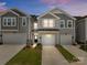Charming townhome featuring a one-car garage, inviting facade, and well-maintained landscaping at 5625 Axil Ln, Charlotte, NC 28269