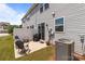 Back exterior of home with outdoor seating and a grill, situated beside a privacy fence and the home at 5625 Axil Ln, Charlotte, NC 28269