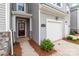 Close-up of the front entrance featuring a garage, walkway, and manicured landscaping at 5625 Axil Ln, Charlotte, NC 28269