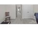 Hallway with neutral walls and carpet with view of doors and stairway leading to other levels at 5625 Axil Ln, Charlotte, NC 28269