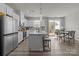 Modern kitchen with stainless steel appliances, a large island, and an adjacent dining area at 5625 Axil Ln, Charlotte, NC 28269