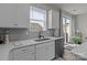Beautiful kitchen with white cabinets, stainless steel appliances, and a view to the backyard at 5625 Axil Ln, Charlotte, NC 28269
