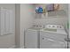 Functional laundry room with modern appliances and shelving for storage solutions at 5625 Axil Ln, Charlotte, NC 28269