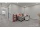 Comfortable living room with a cozy gray couch, ottoman, and neutral décor at 5625 Axil Ln, Charlotte, NC 28269
