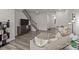 Comfortable living room with plush seating, hardwood floors, and staircase view at 5625 Axil Ln, Charlotte, NC 28269