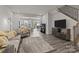 Spacious living room with hardwood floors and an open view to the kitchen and dining area at 5625 Axil Ln, Charlotte, NC 28269