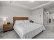 Inviting main bedroom with a large bed, tray ceiling, and windows for natural light at 5625 Axil Ln, Charlotte, NC 28269