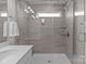 Contemporary tiled walk-in shower with sleek glass door and window for natural light at 5625 Axil Ln, Charlotte, NC 28269