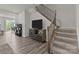 Living room view with staircase featuring a carpeted steps and decorative iron balusters at 5625 Axil Ln, Charlotte, NC 28269