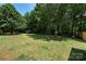 Lush backyard, enclosed by a fence and mature trees providing shade at 5764 Grassy Creek Rd, Denver, NC 28037