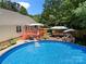 Lovely backyard with a sparkling pool, spacious deck, and outdoor seating, creating an ideal entertaining space at 5764 Grassy Creek Rd, Denver, NC 28037