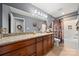 Granite vanity with dual sinks, and a neutral-toned shower and tile flooring at 5764 Grassy Creek Rd, Denver, NC 28037