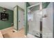 Bathroom with a shower, featuring a vanity and coordinated green and white accents at 5764 Grassy Creek Rd, Denver, NC 28037