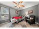 Charming bedroom with cozy armchair, buffalo check bedding, and a window with natural light at 5764 Grassy Creek Rd, Denver, NC 28037
