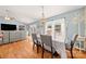 Dining room with hardwood floors, modern chandelier, and natural light from the windows at 5764 Grassy Creek Rd, Denver, NC 28037