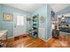 Charming entryway featuring hardwood floors, a decorative bench, and a view into a cozy bedroom at 5764 Grassy Creek Rd, Denver, NC 28037