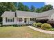 Attractive ranch home with a well-kept lawn, complemented by lush greenery and a charming front porch at 5764 Grassy Creek Rd, Denver, NC 28037