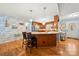 Open kitchen featuring a breakfast bar, hardwood floors, and a view into the dining and entry areas at 5764 Grassy Creek Rd, Denver, NC 28037