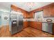 Spacious kitchen featuring stainless steel appliances, wooden cabinetry, and hardwood flooring at 5764 Grassy Creek Rd, Denver, NC 28037