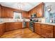 Well-lit kitchen with stainless steel appliances, granite countertops, and ample wooden cabinetry at 5764 Grassy Creek Rd, Denver, NC 28037